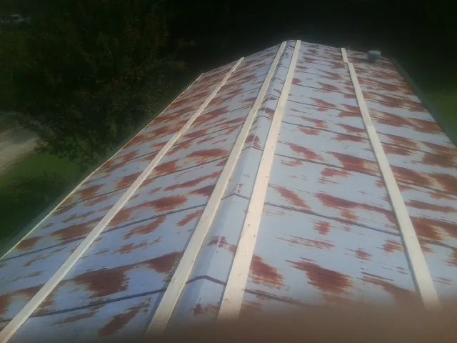 Rusted metal roof panels with new wood purlins before replacement — Storm Damage Roof Repair in Ecorse by Roofing Brothers